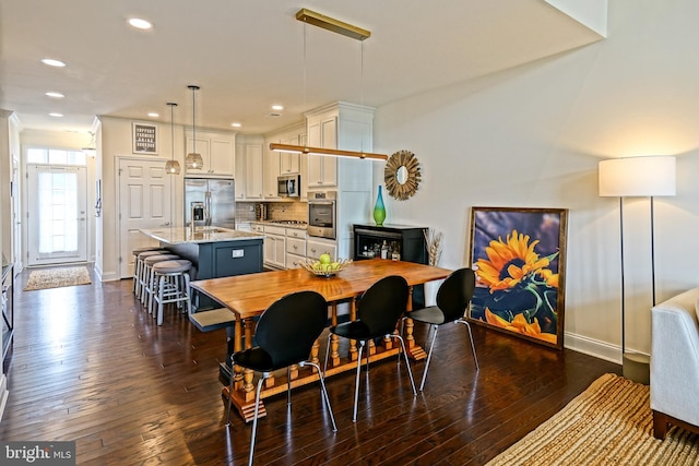 dining room with dark hardwood / wood-style flooring