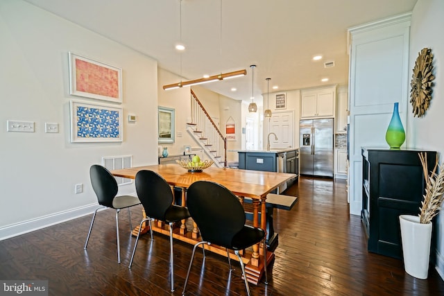 dining room with dark wood-type flooring and sink