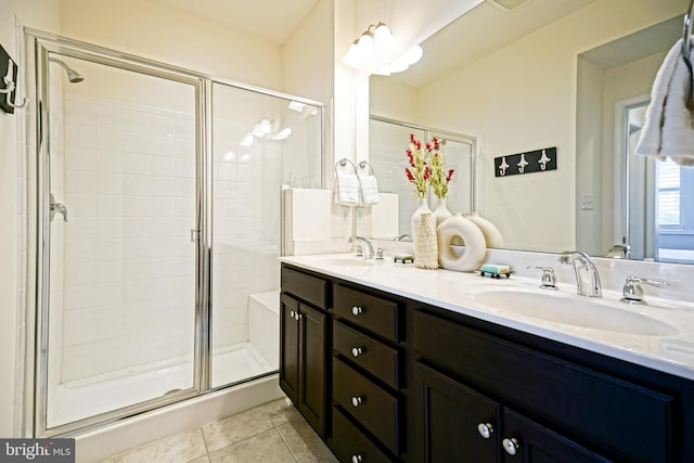 bathroom featuring tile patterned flooring, vanity, and walk in shower