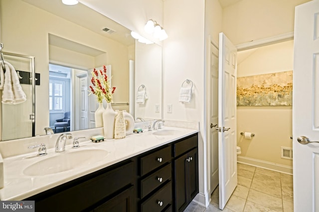 bathroom featuring tile patterned floors, toilet, and vanity