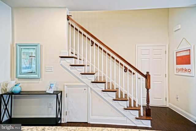 staircase featuring wood-type flooring