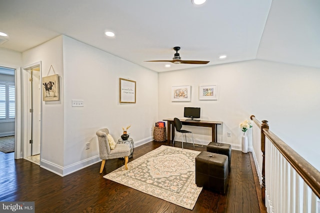 living area with dark wood-type flooring and ceiling fan