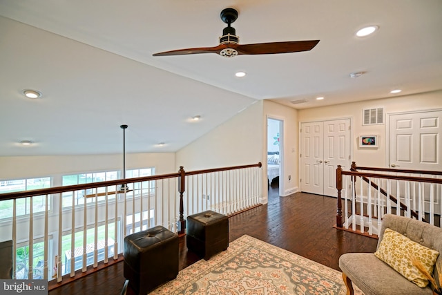 interior space with lofted ceiling, dark wood-type flooring, and ceiling fan