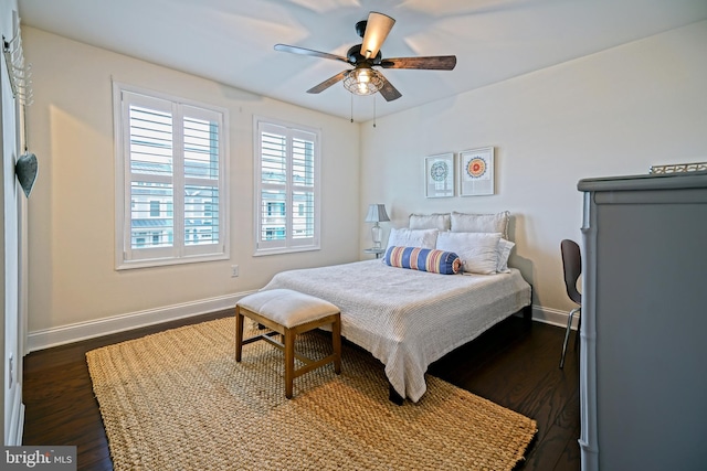 bedroom with dark hardwood / wood-style flooring and ceiling fan