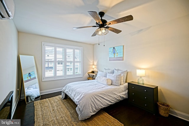 bedroom with ceiling fan, dark hardwood / wood-style floors, and a wall mounted air conditioner