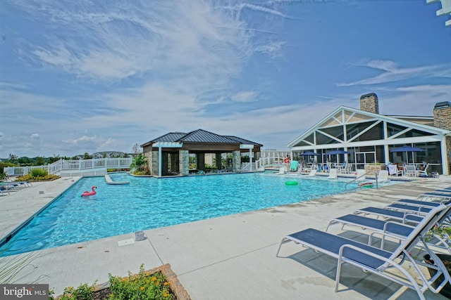 view of swimming pool featuring a patio and a gazebo