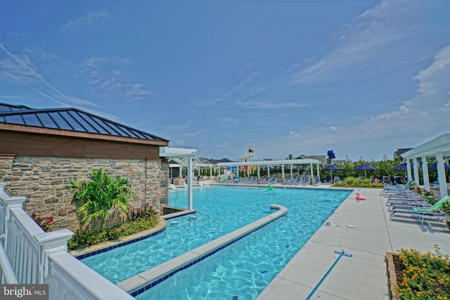 view of swimming pool with a pergola and a patio