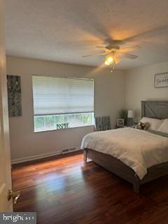 bedroom featuring ceiling fan and dark hardwood / wood-style floors