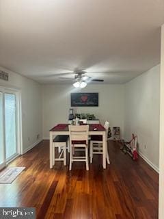 dining area featuring dark wood-type flooring and ceiling fan