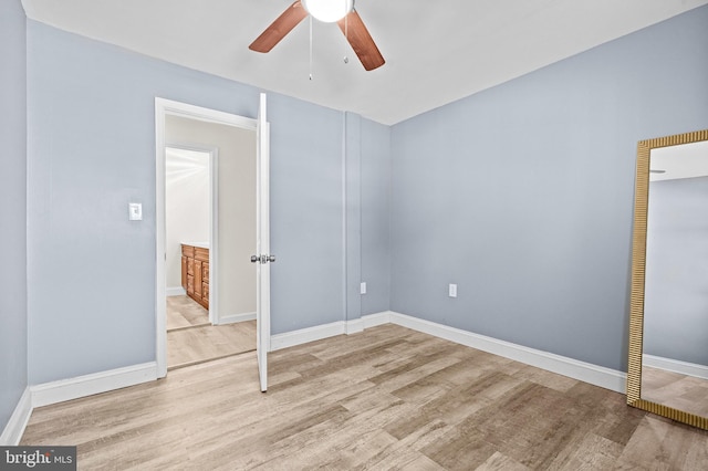 unfurnished bedroom featuring light hardwood / wood-style flooring, a closet, and ceiling fan