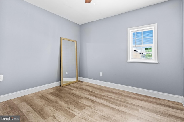 empty room featuring light hardwood / wood-style flooring and ceiling fan