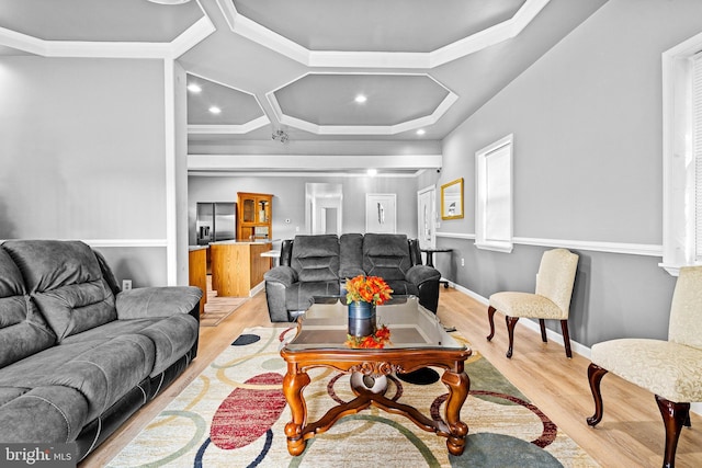 living room featuring crown molding, coffered ceiling, and light wood-type flooring