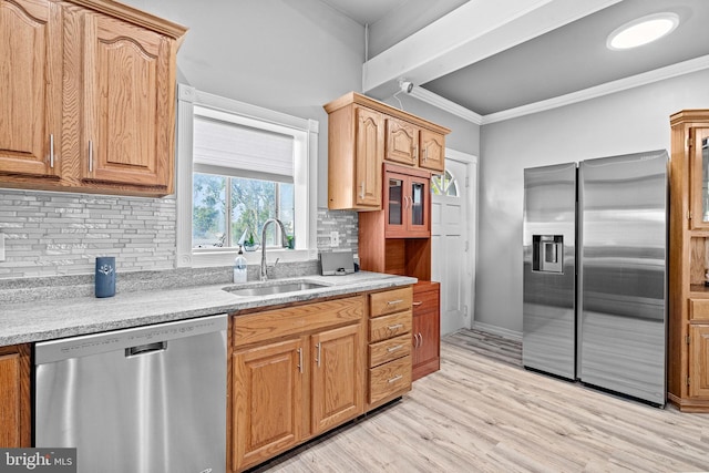 kitchen featuring sink, crown molding, stainless steel appliances, tasteful backsplash, and light hardwood / wood-style floors