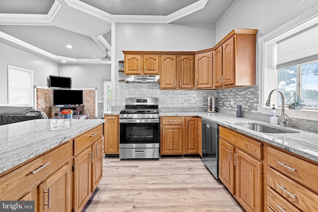 kitchen featuring dishwasher, stainless steel range with gas cooktop, sink, and light stone counters