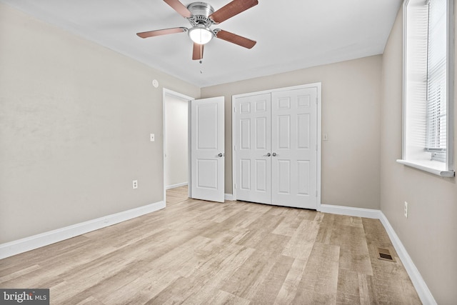 unfurnished bedroom featuring a closet, ceiling fan, and light hardwood / wood-style flooring