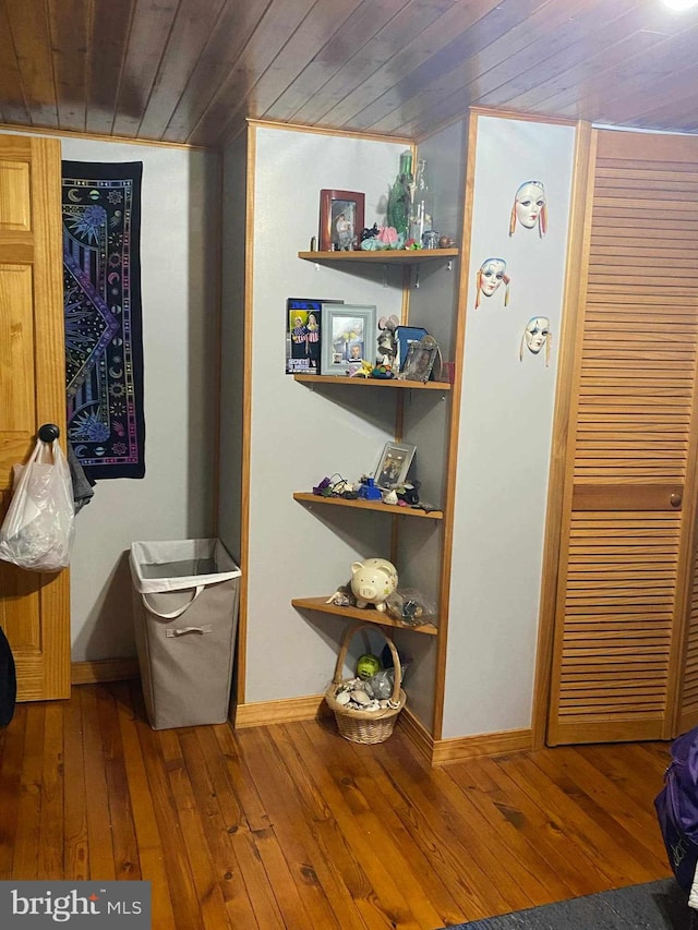 hallway featuring wooden ceiling and wood-type flooring