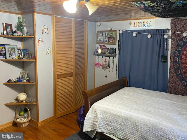 bedroom with ceiling fan, wood ceiling, and wood-type flooring