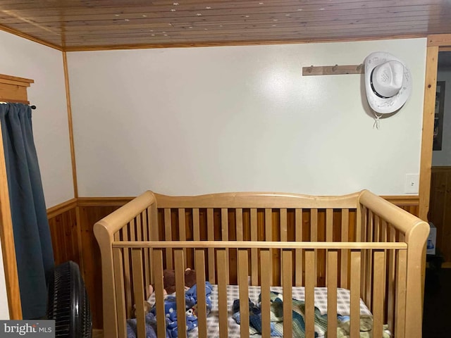 unfurnished bedroom featuring wooden ceiling and a crib