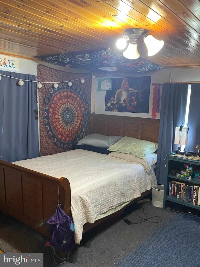 carpeted bedroom featuring wooden ceiling