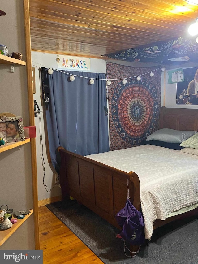 bedroom with wood-type flooring and wood ceiling