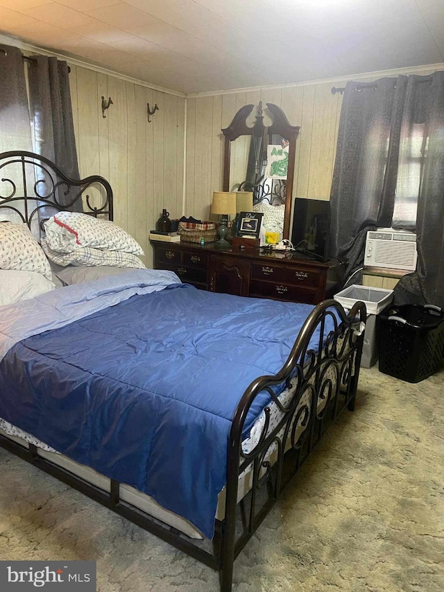 bedroom featuring wood walls, carpet flooring, ornamental molding, and cooling unit