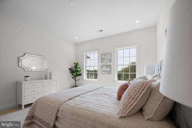 bedroom featuring light colored carpet