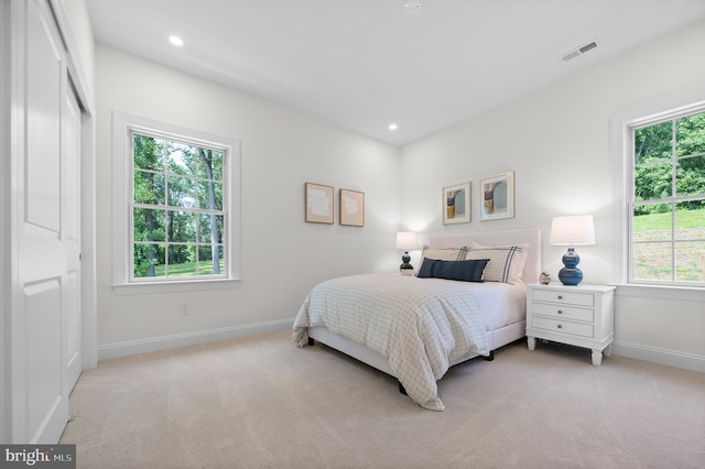 bedroom featuring light colored carpet