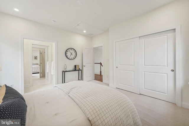 bedroom featuring light colored carpet and a closet