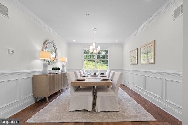 dining area featuring an inviting chandelier, ornamental molding, and dark hardwood / wood-style flooring