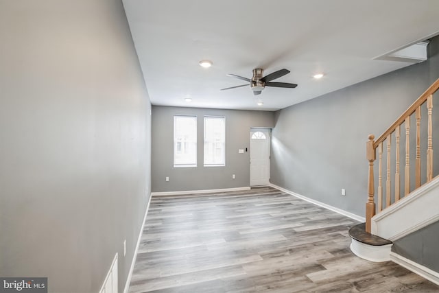 foyer entrance with ceiling fan and light hardwood / wood-style flooring