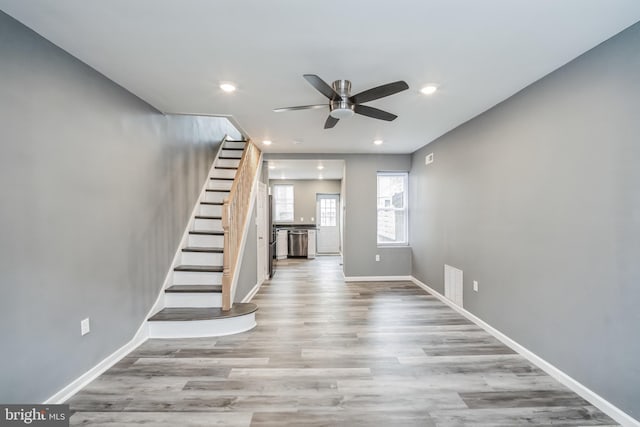 interior space with ceiling fan and light hardwood / wood-style flooring