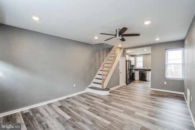 unfurnished living room with light hardwood / wood-style floors and ceiling fan