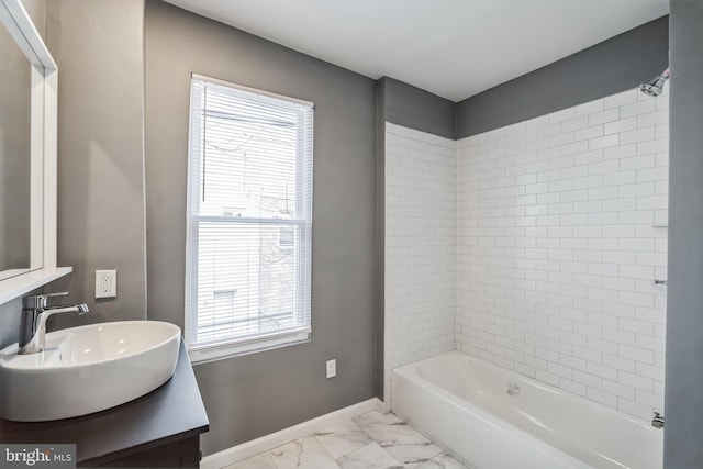 bathroom with tiled shower / bath combo and vanity