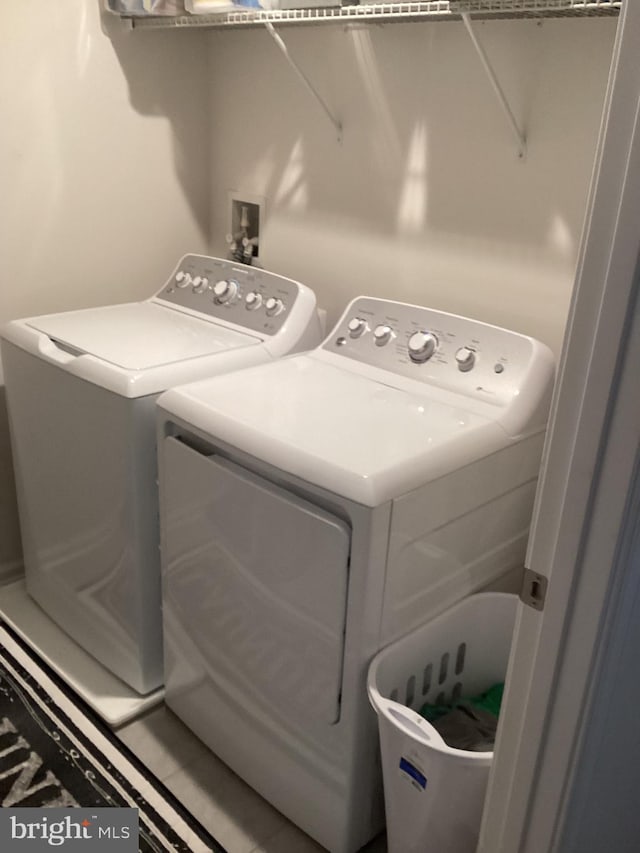 laundry area with washing machine and clothes dryer