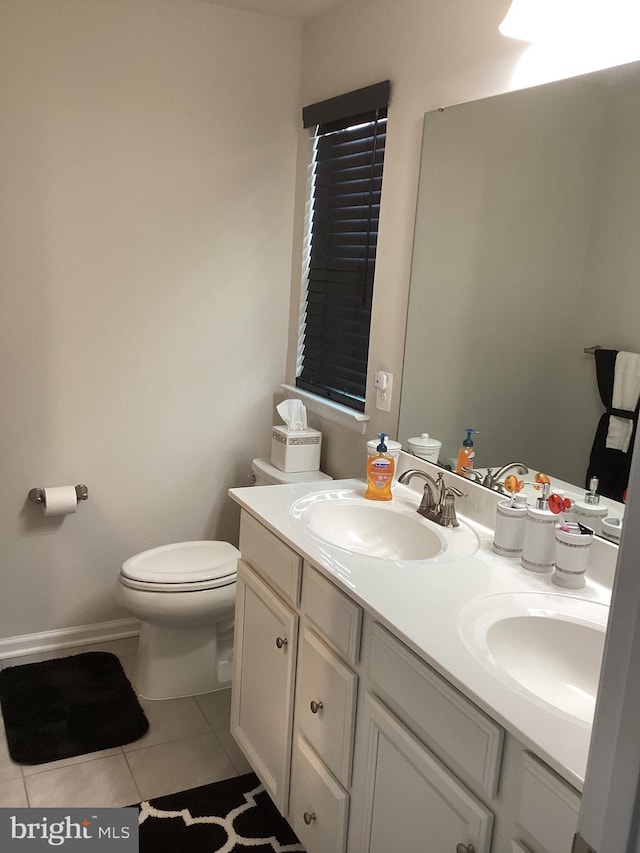 bathroom featuring tile patterned flooring, vanity, and toilet