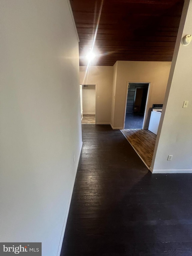 hallway featuring wood ceiling and dark hardwood / wood-style floors