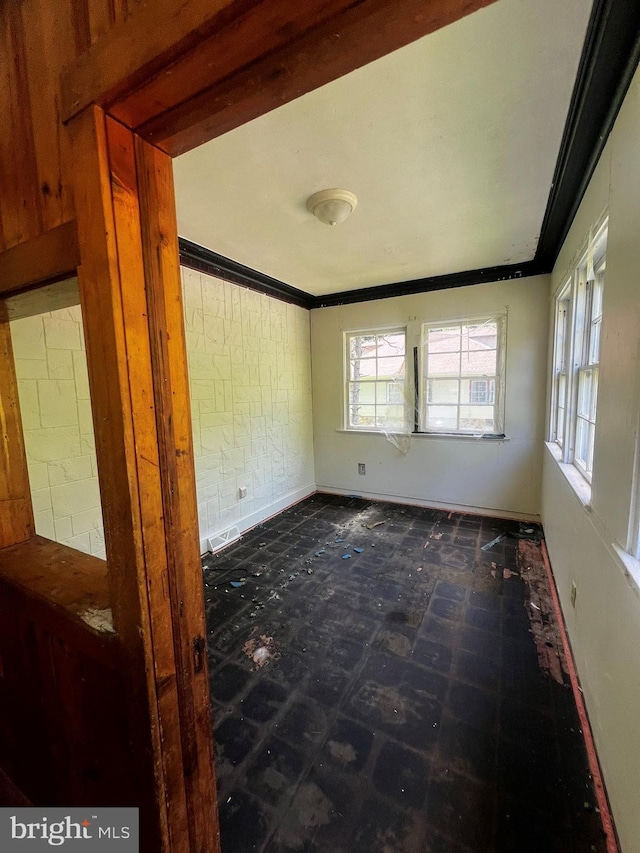 unfurnished room featuring ornamental molding