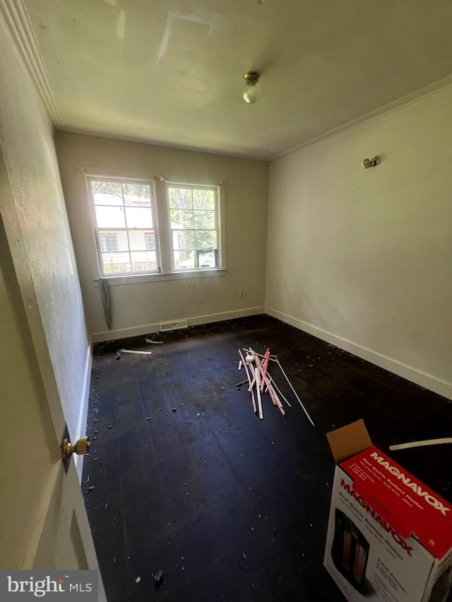 spare room with crown molding and wood-type flooring