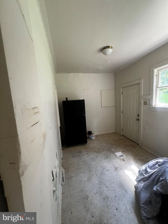 interior space with black refrigerator