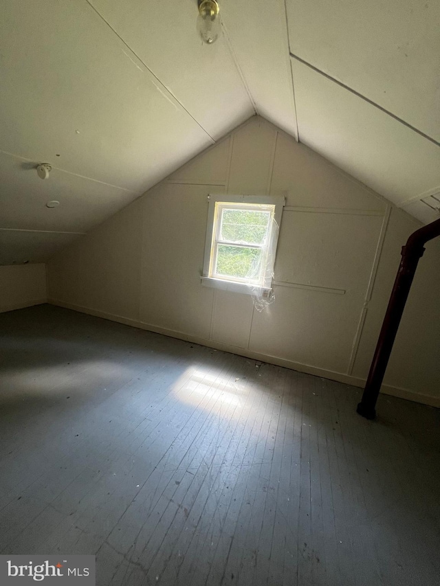 bonus room with hardwood / wood-style flooring and lofted ceiling