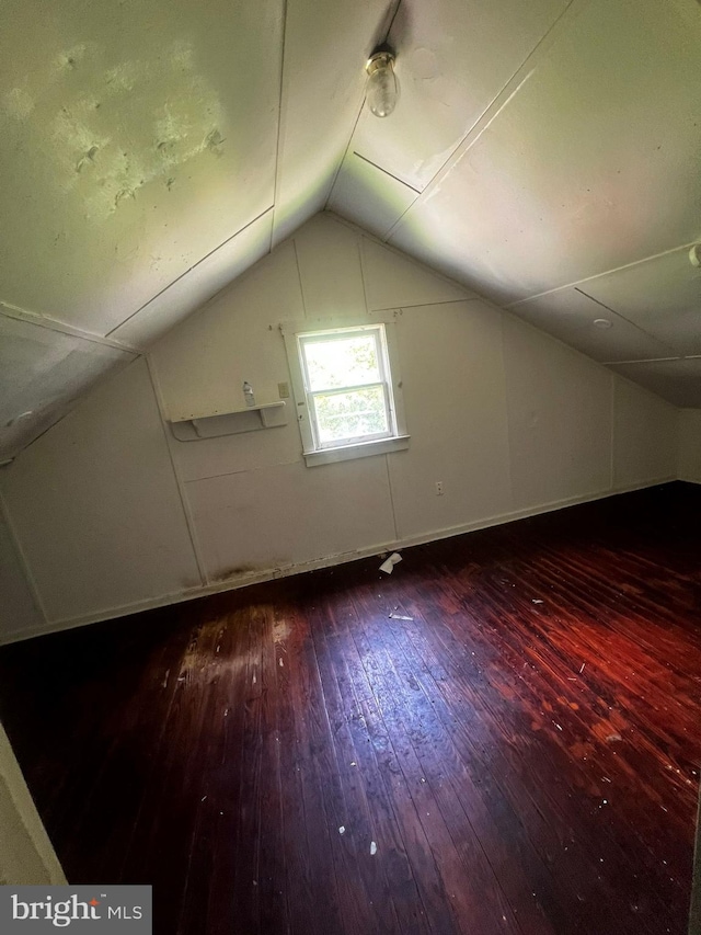 bonus room with vaulted ceiling and wood-type flooring