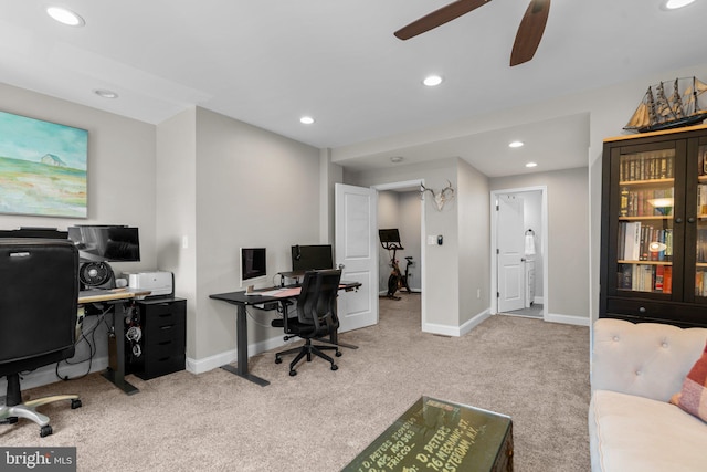 carpeted office space featuring ceiling fan