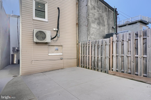 view of side of property featuring a patio and ac unit