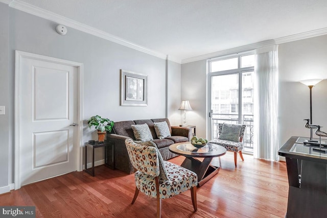 living room with wood finished floors and crown molding