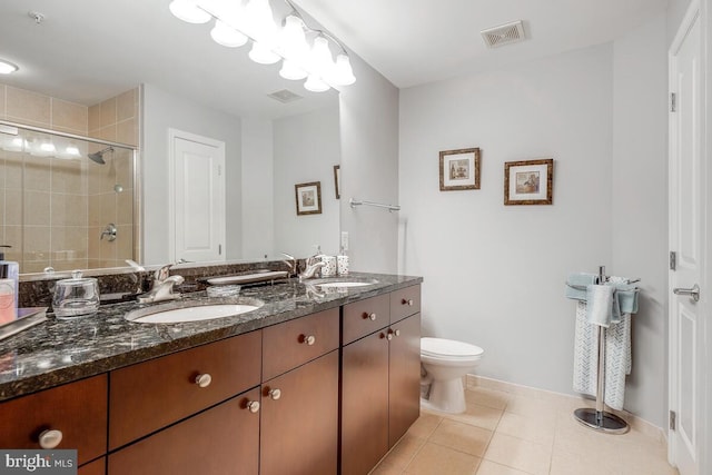 full bath with visible vents, a sink, a shower stall, and tile patterned floors