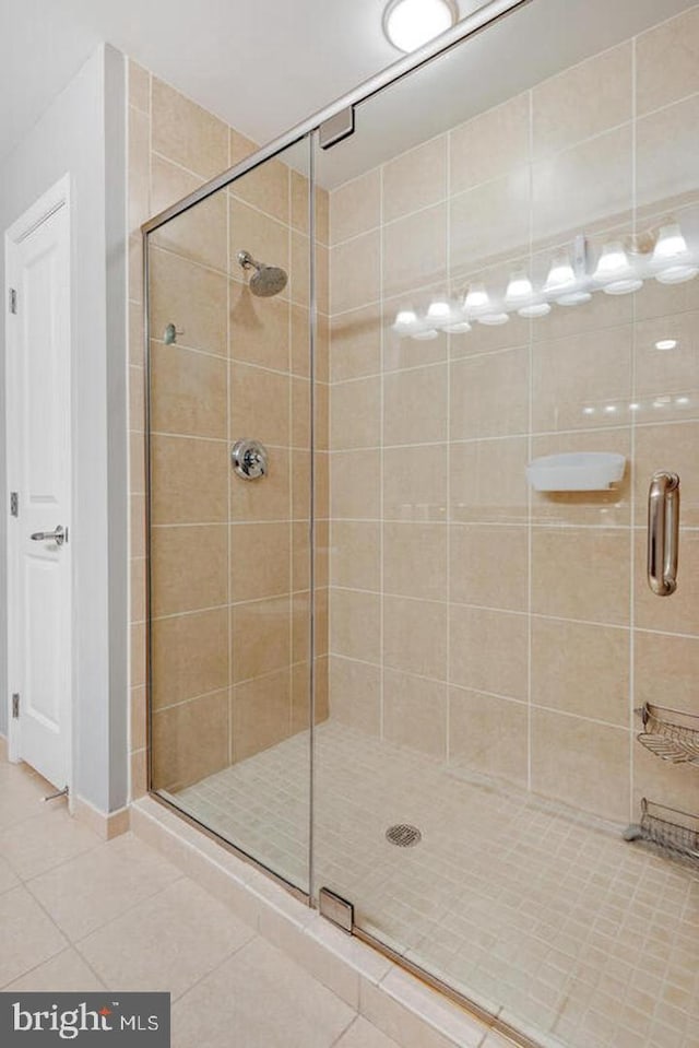 full bath featuring a stall shower and tile patterned floors