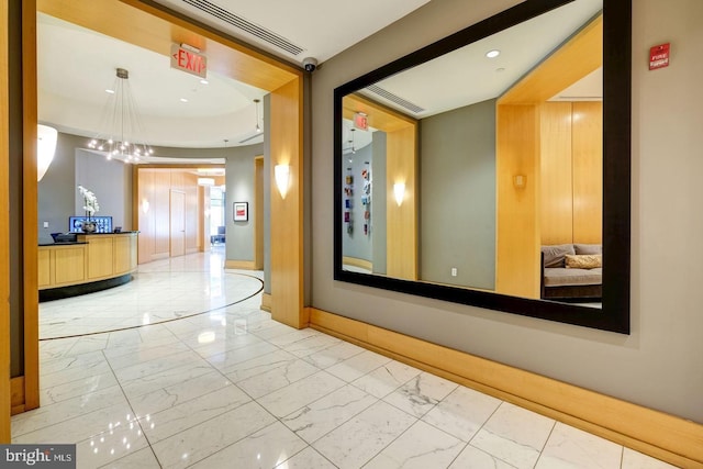 corridor featuring marble finish floor, visible vents, and baseboards