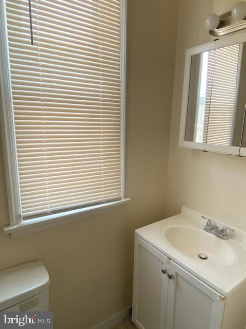 bathroom featuring toilet and vanity