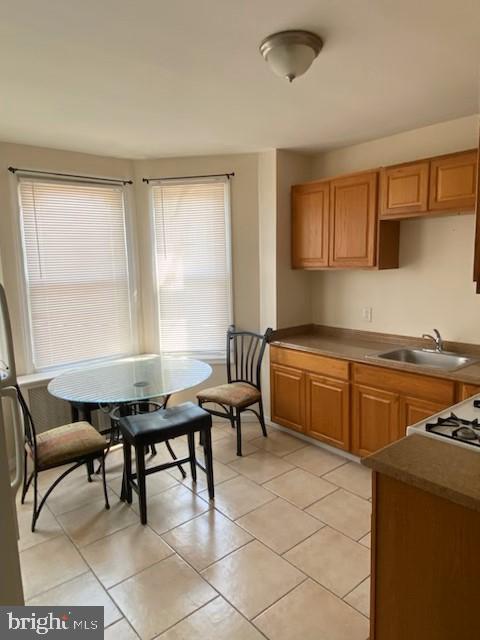 kitchen with sink and light tile patterned flooring