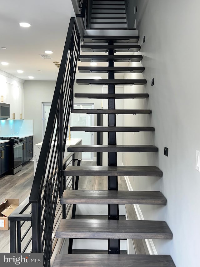 stairs with hardwood / wood-style flooring